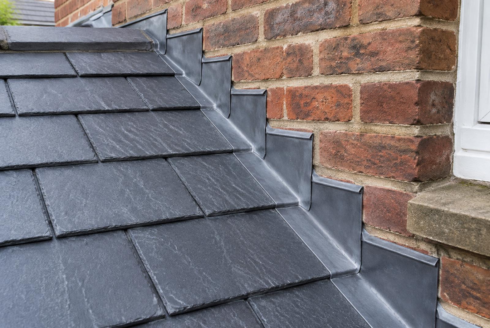 Stepped lead flashing where a slate roof meets a brick wall