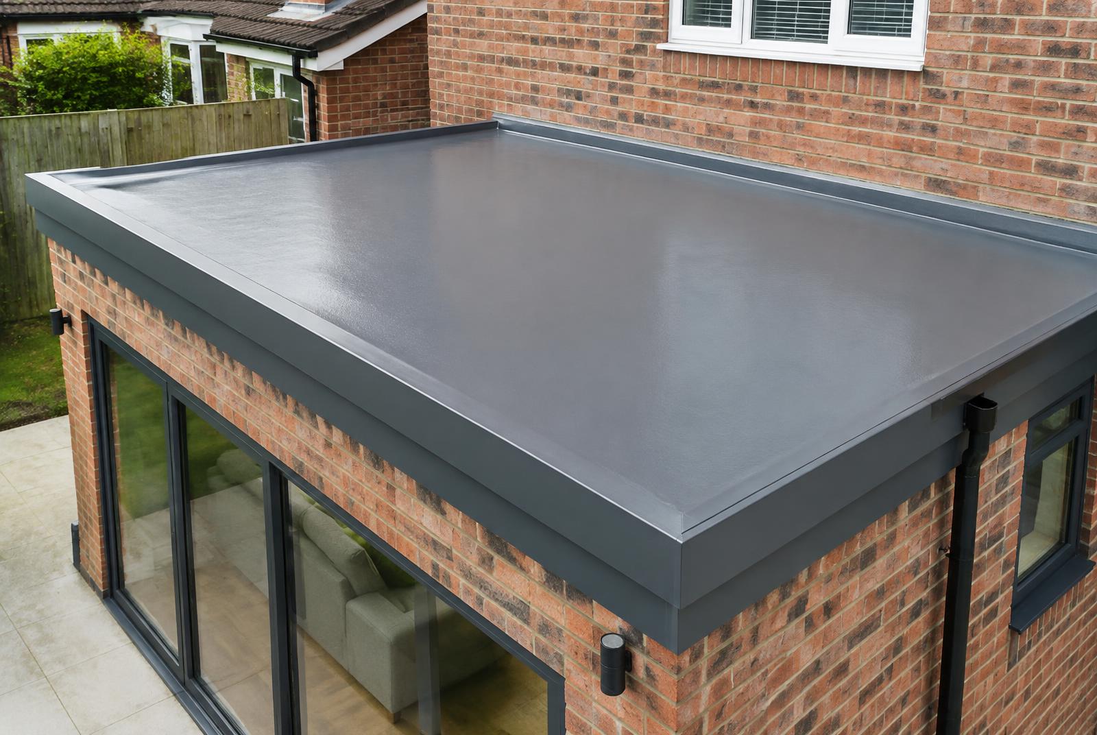 Completed grey GRP fibreglass flat roof on a rear extension